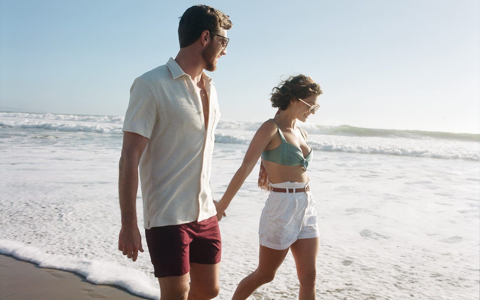 Couple walking along the shore