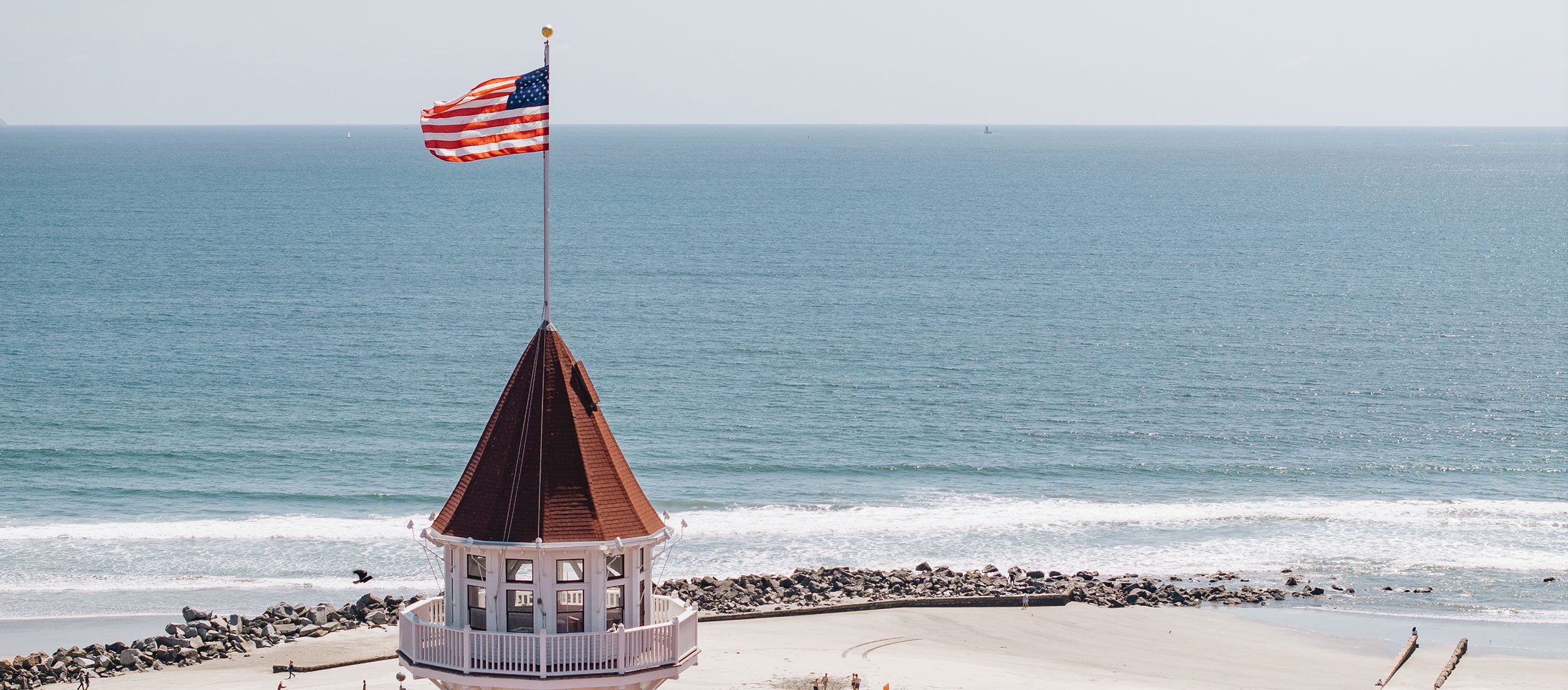 Victorian turret, American flag, and ocean