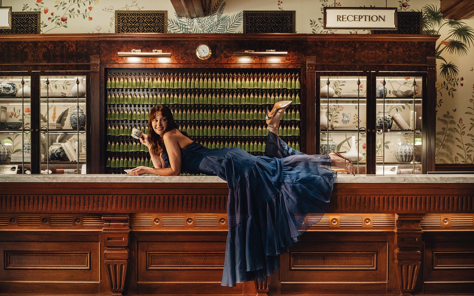 Woman laying on front desk with a teacup