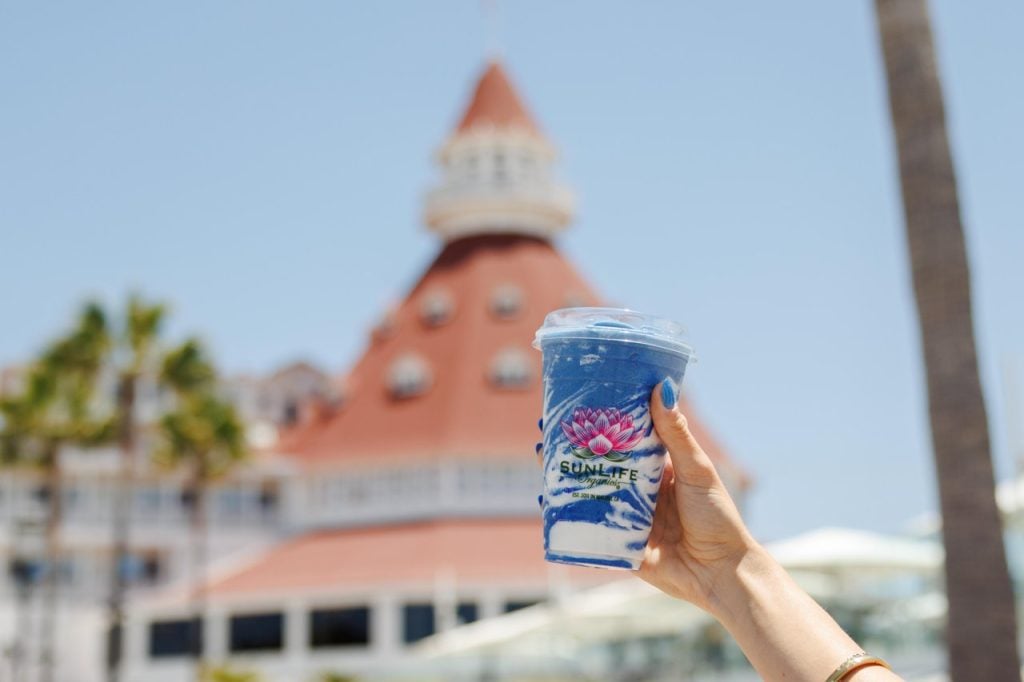 Hand holding blue smoothie