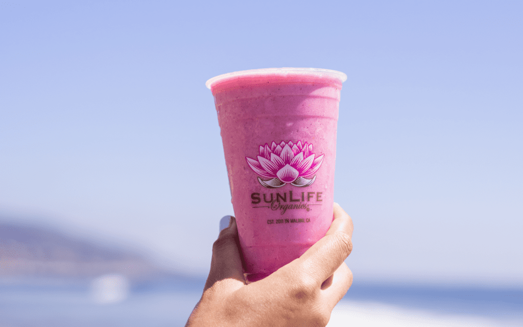 hand holding pink sunlife smoothie