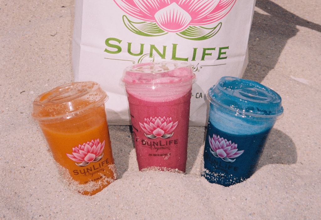 three sunlife smoothies in the sand