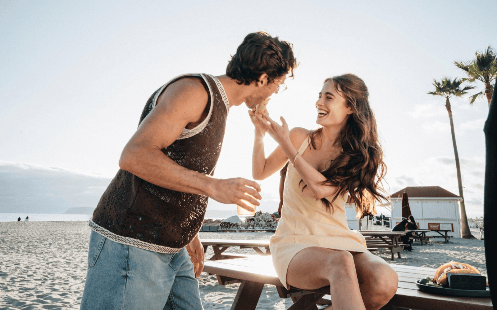Couple eating tacos on the beach